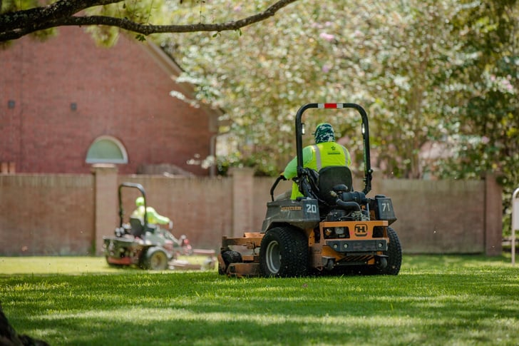 landscape crew mowing grass