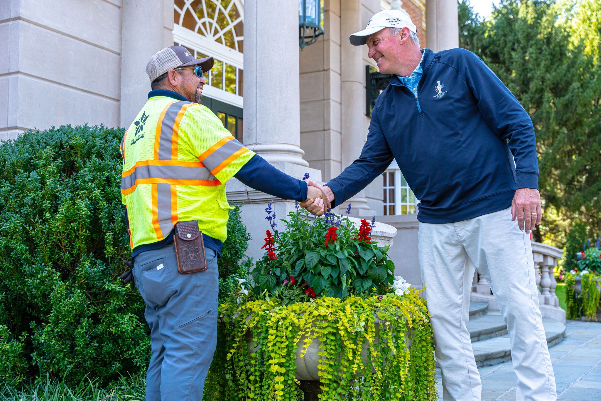 client shaking hand with landscaper 