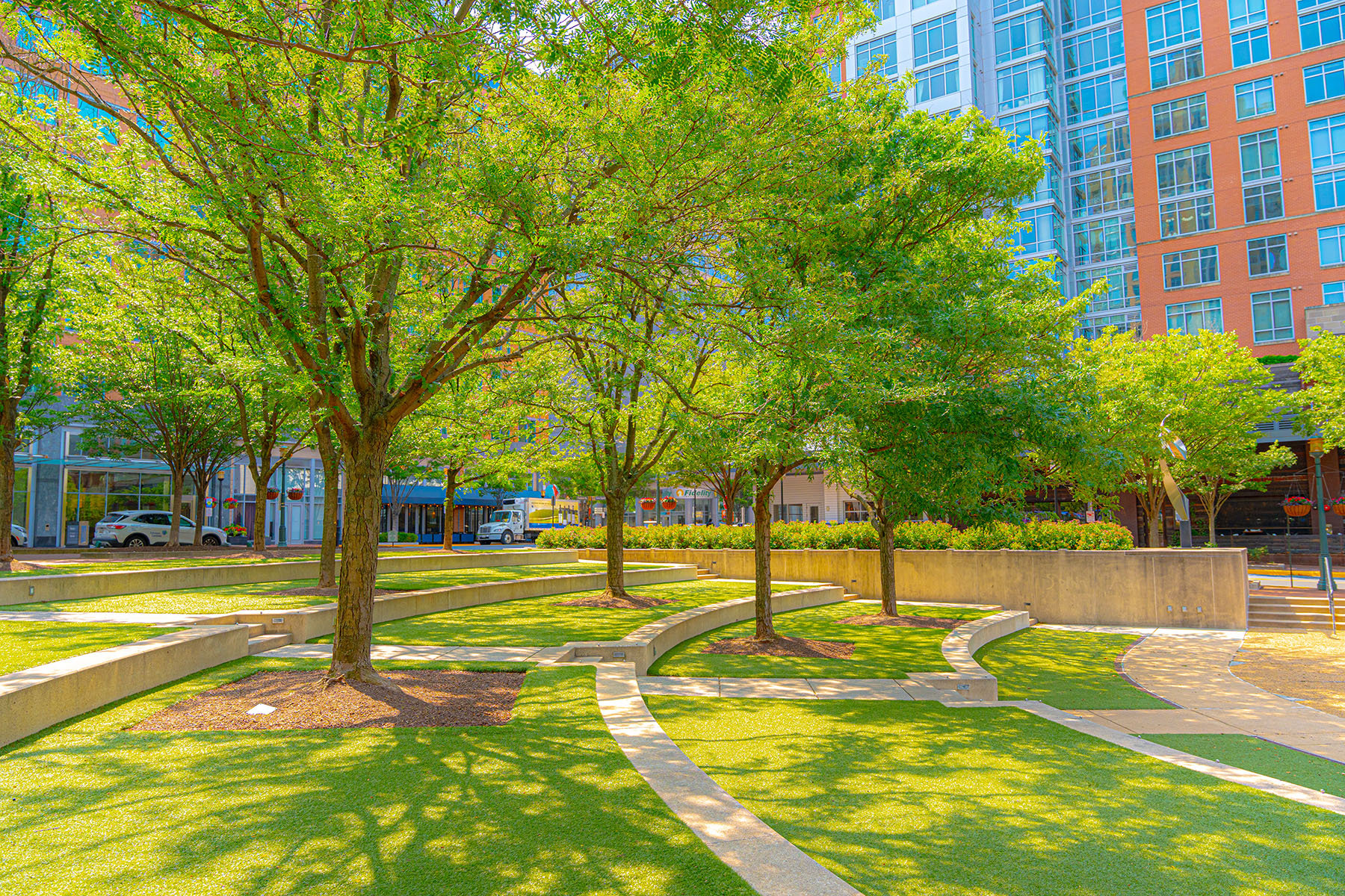 Green trees and turf in mixed use development center 