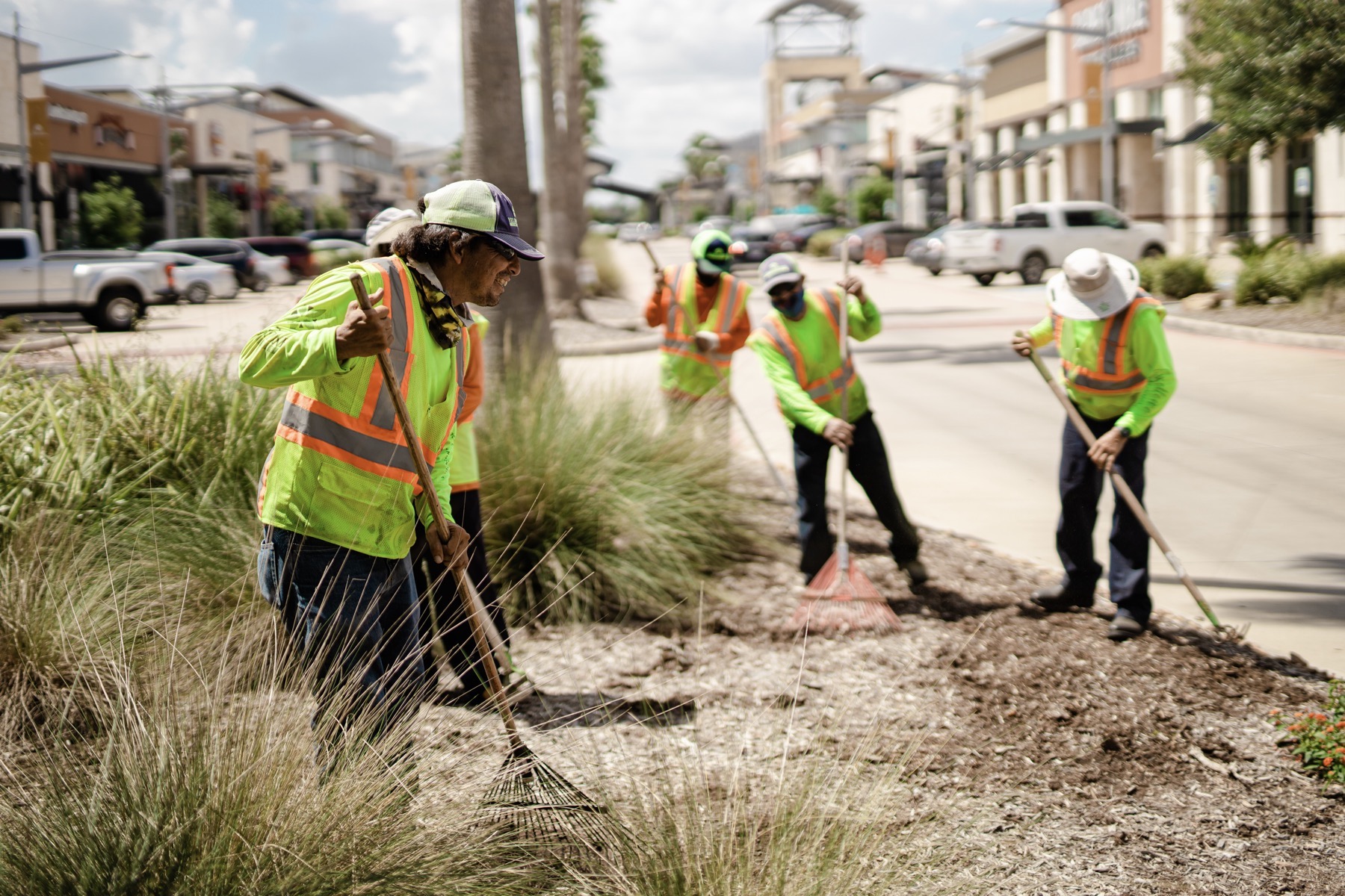 Yellowstone maintenance crew mulching a landscape bed in Dallas, TX