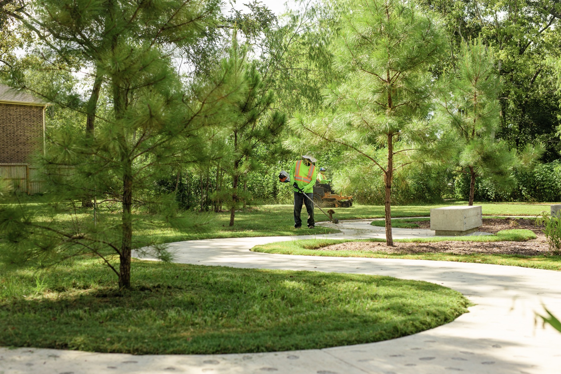 Lawn care team trimming